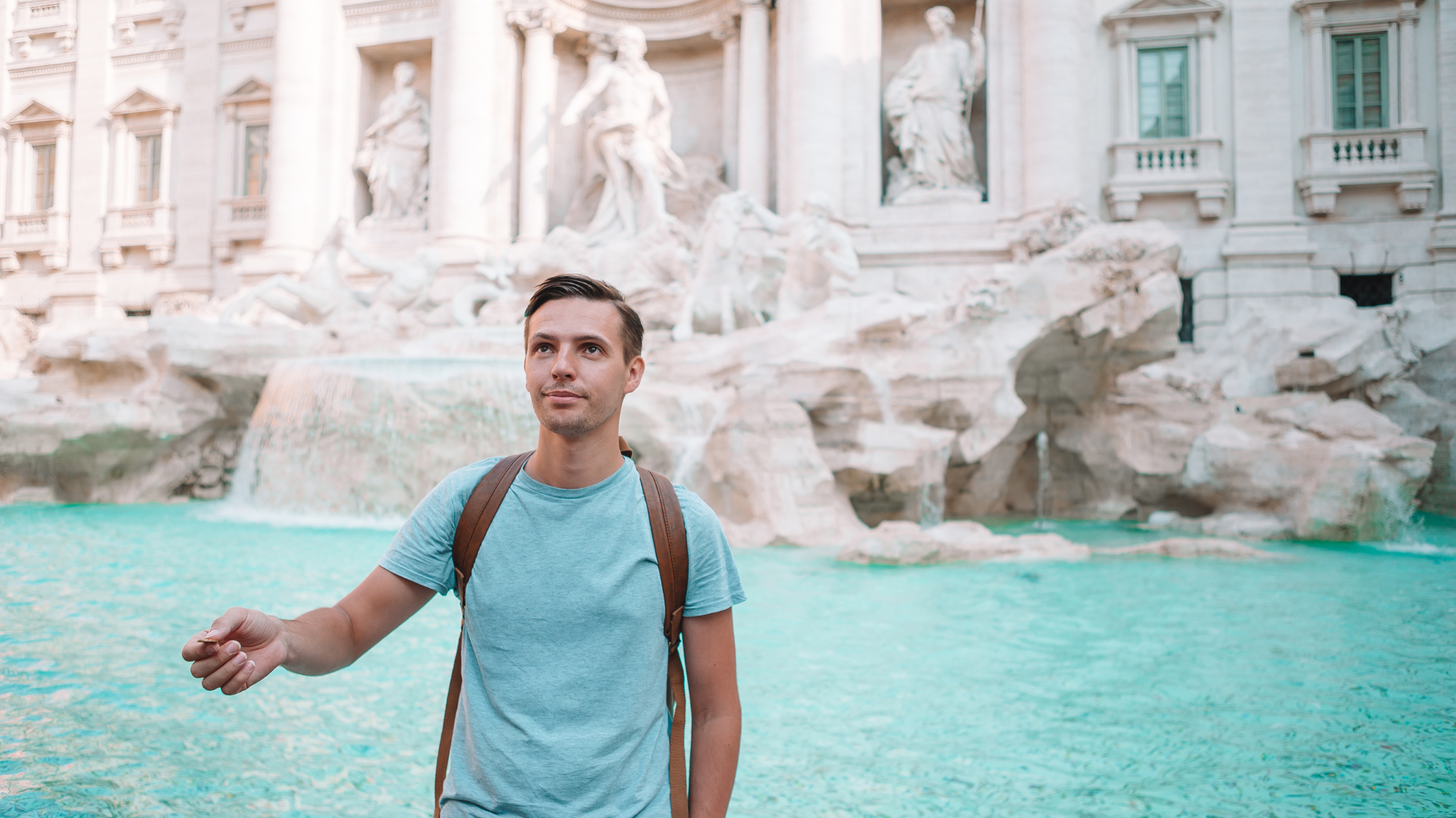 Tossing coin into Trevi Fountain